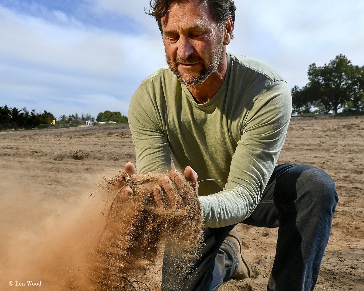 Will Henry sifts sand in the open ground that is to become the first estate vineyard for Lumen Wines, in Orcutt.